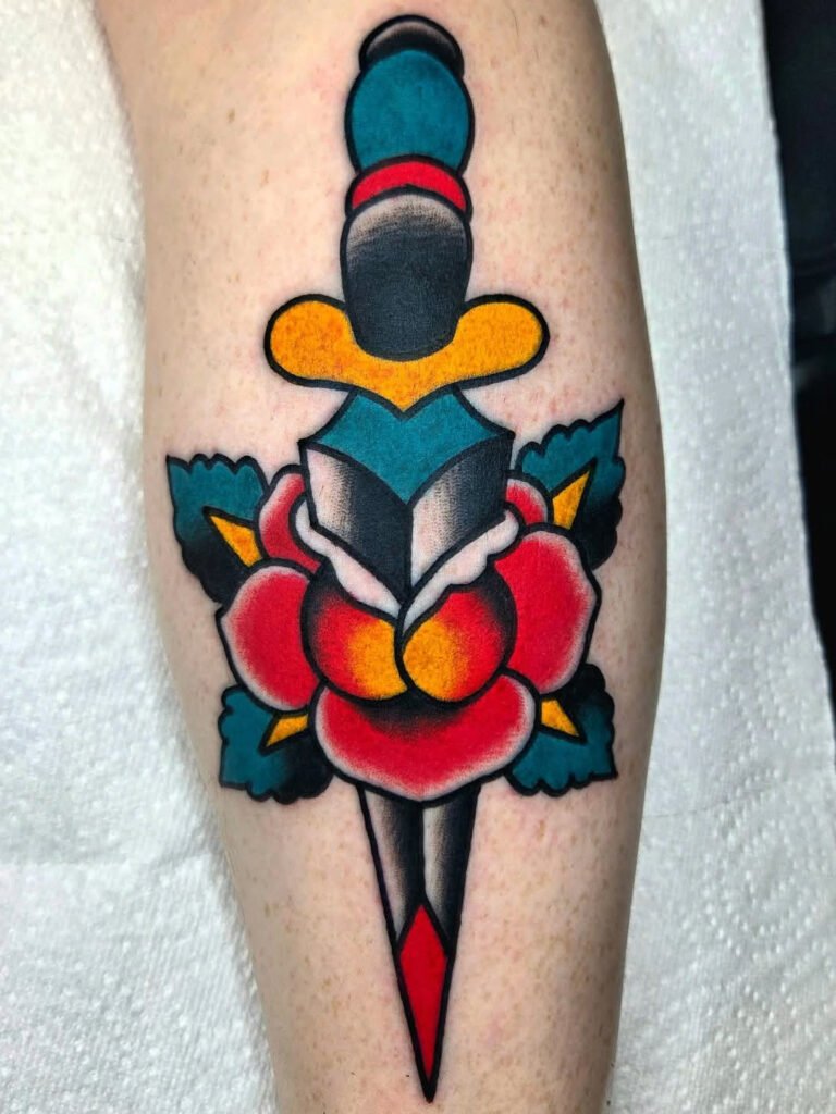 An American traditional dagger and rose tattoo. This tattoo was made by Noah Beach, co owner of Near Me Tattoo at 6721 Bells Ferry Rd Ste D110 Woodstock, Ga. 30189