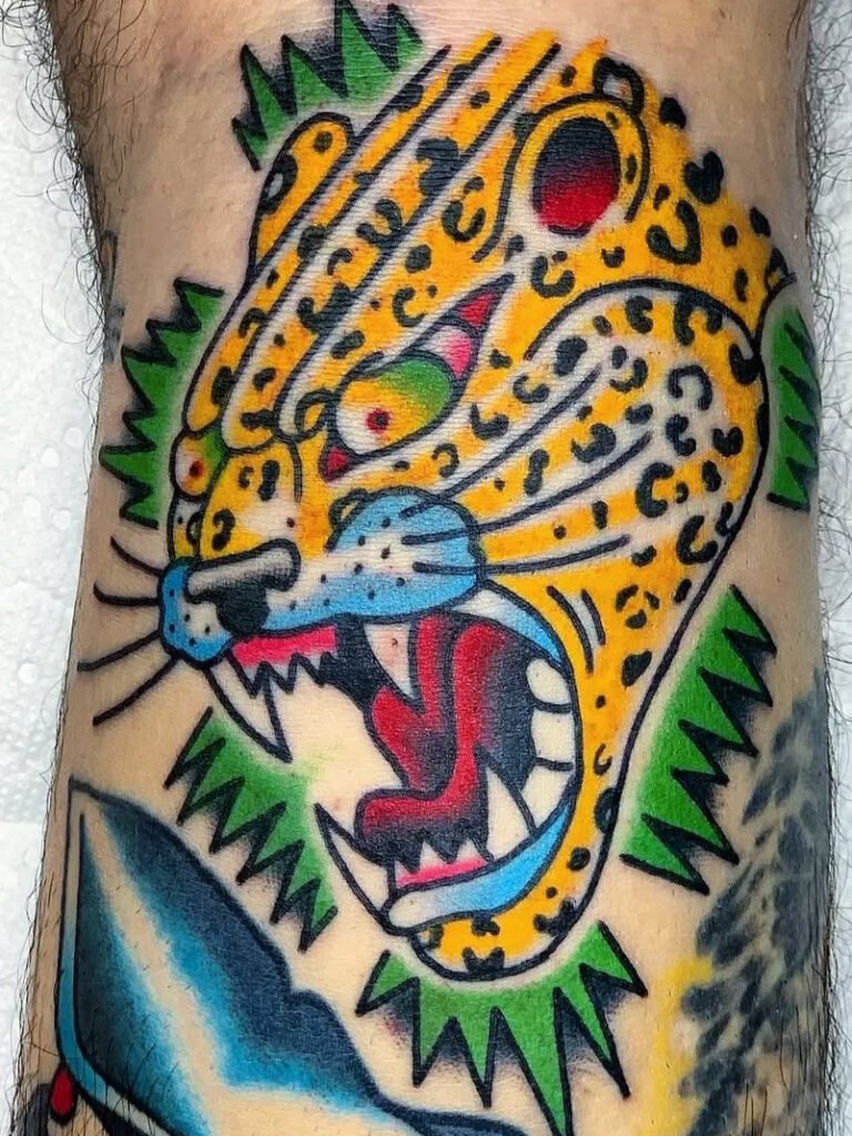 An American traditional Jaguar head tattoo. The Jaguars fur is bright yellow and it its expression is angry. This tattoo was made by Noah Beach, co owner of Near Me Tattoo at 6721 Bells Ferry Rd Ste D110 Woodstock, Ga. 30189