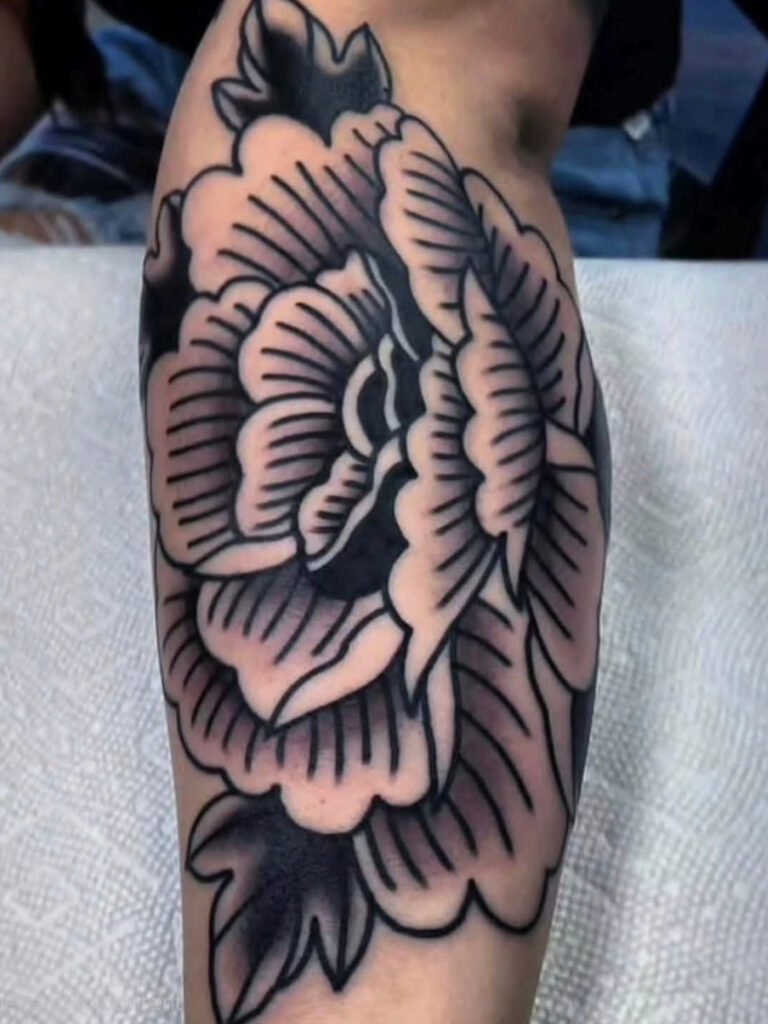 A blackwork Japanese style peony tattoo. Its outer petals are solid black and its inner petals are shaded with parallel accent lines. This tattoo was made by Noah Beach, co owner of Near Me Tattoo at 6721 Bells Ferry Rd Ste D110 Woodstock, Ga. 30189
