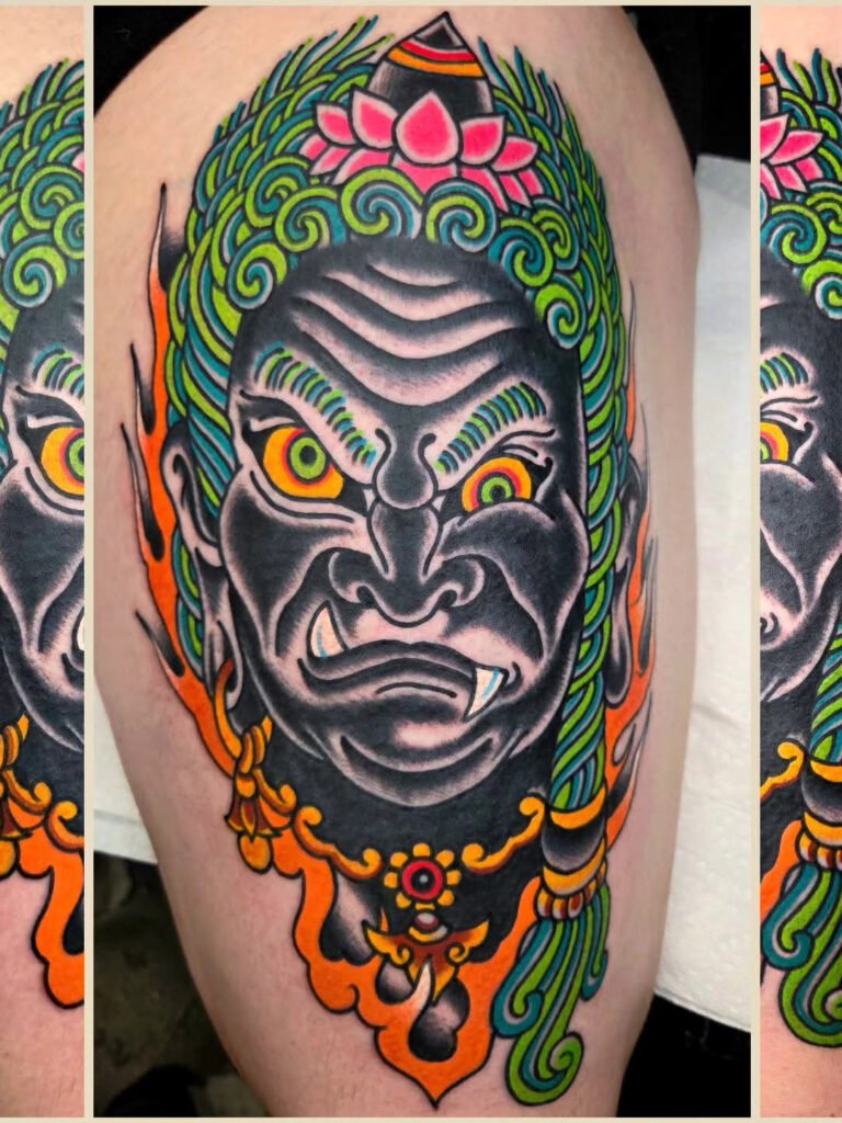 a traditional Japanese style fudo tattoo. It is the head of the fudo with flames coming down creating a bottom frame. This tattoo was made by Noah Beach, co owner of Near Me Tattoo at 6721 Bells Ferry Rd Ste D110 Woodstock, Ga. 30189