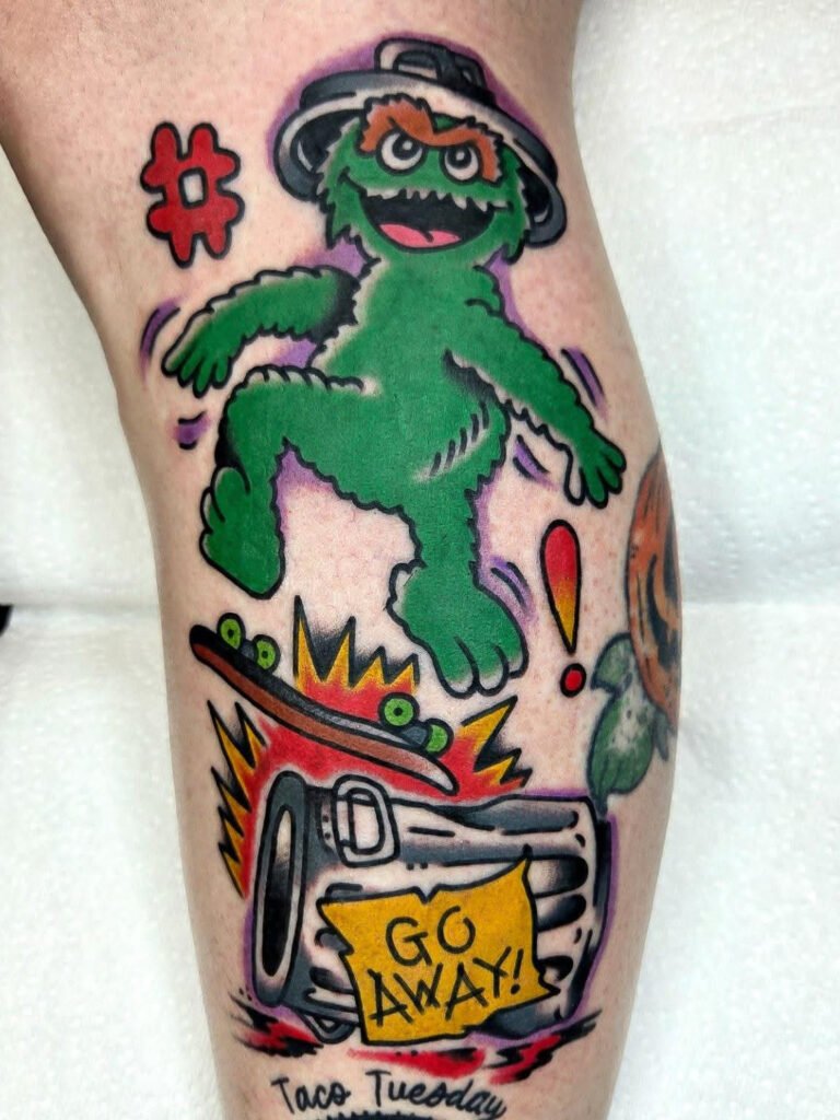 A Neo traditional tattoo of Oscar the grouch from Sesame Street skateboarding. His trash can that he is doing a trick of of has a sign that says “go away” This tattoo was made by Noah Beach, co owner of Near Me Tattoo at 6721 Bells Ferry Rd Ste D110 Woodstock, Ga. 30189