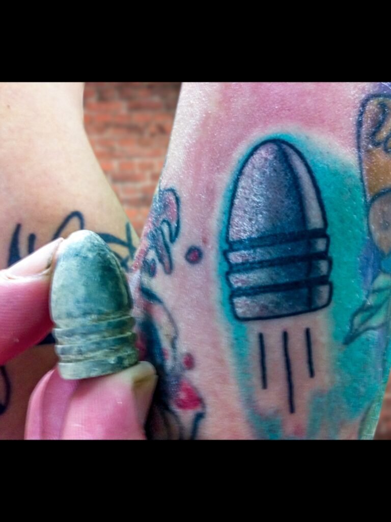 A Neo traditional tattoo of a civil war three ring drop bullet from the American Civil war. The image has an authentic drop bullet in the picture that was used as referee to make the tattoo design. The bullet is held in the hand and in the finger of the person who got the tattoo. This tattoo was made by Nathan Heinrich, co owner of Near Me Tattoo at 6721 Bells Ferry Rd Ste D110 Woodstock, Ga. 30189