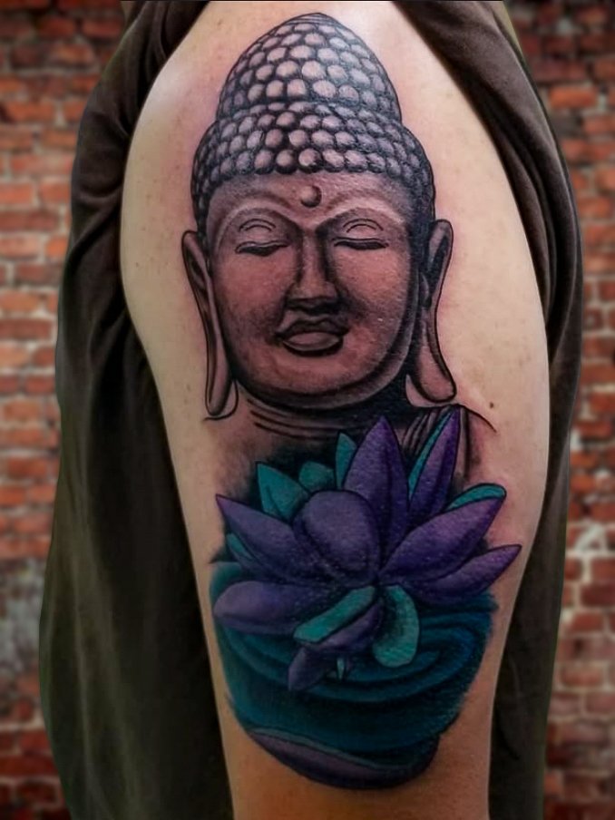 A combination of black and grey or gray ink portrait of the Buddha Shaka with a color ink lotus flower beneath the deity. This is also a cover up tattoo. This tattoo was made by Nathan Heinrich, co owner of Near Me Tattoo at 6721 Bells Ferry Rd Ste D110 Woodstock, Ga. 30189